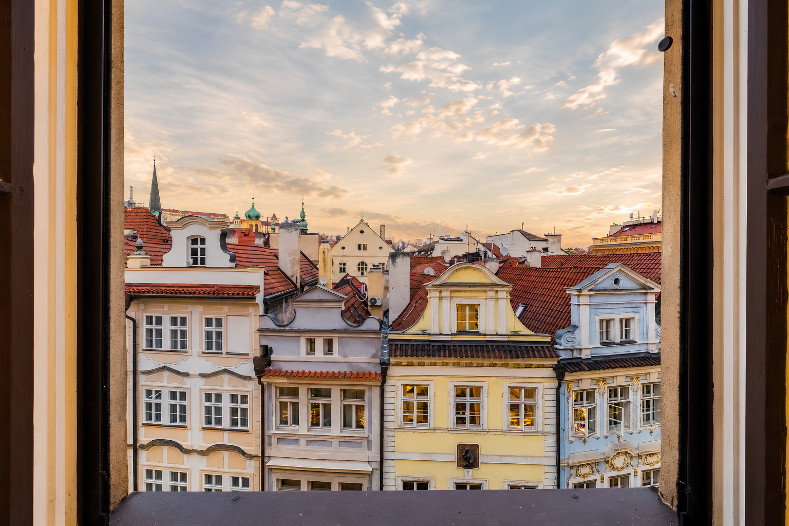 Old Prague rooftops at sunset from the apartment window